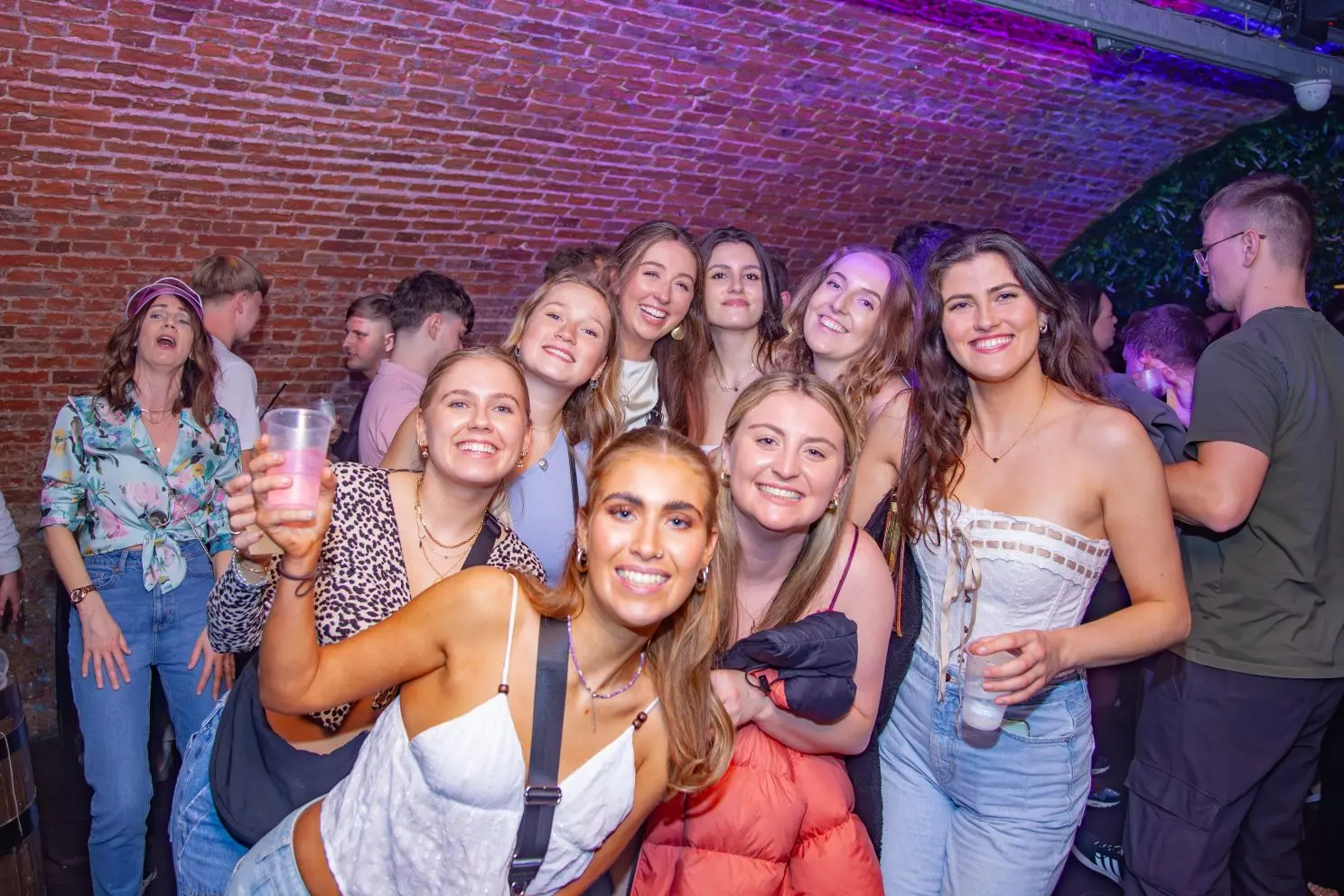 A group of young women pose for a photo in the nightclub